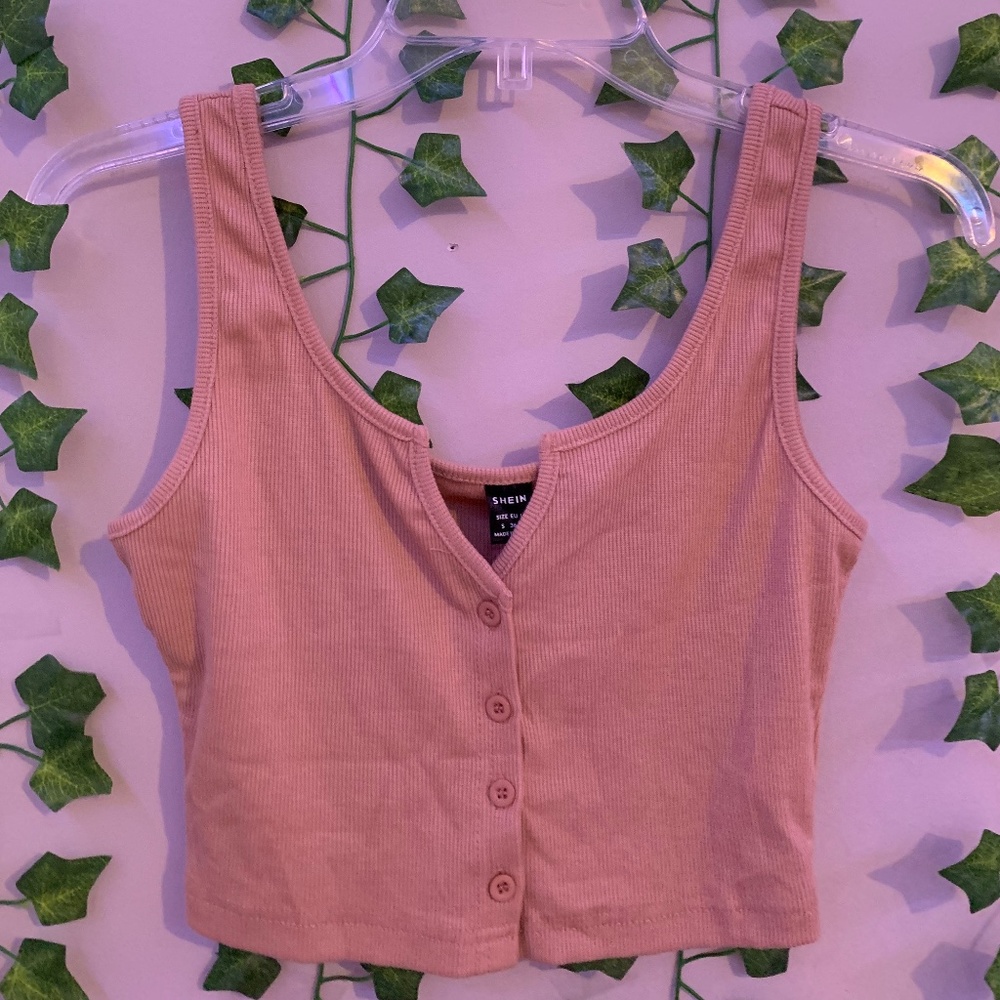 Crop top shirt that has a low neckline with buttons